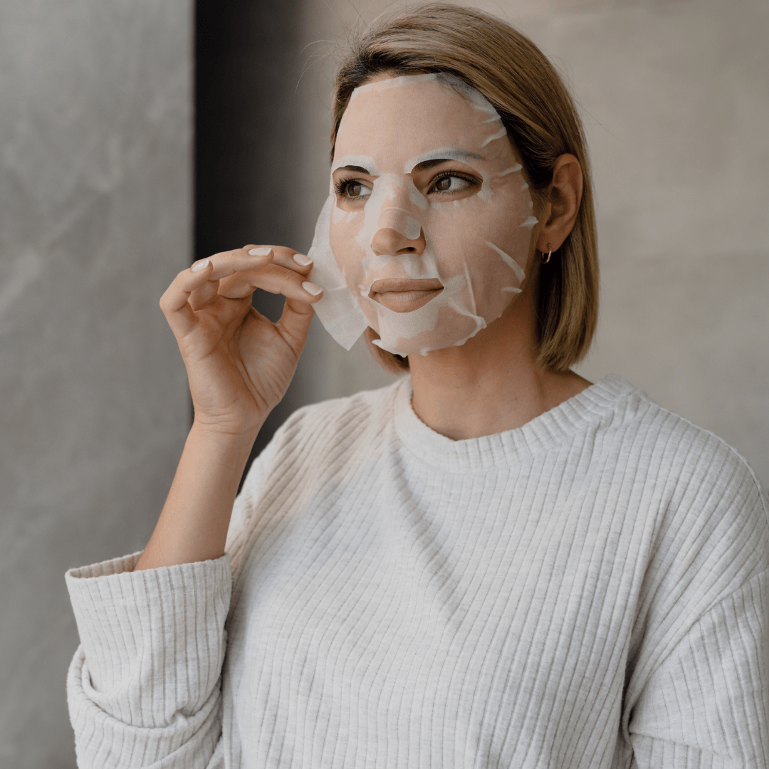 Fruit enzyme sheet mask being pulled off face